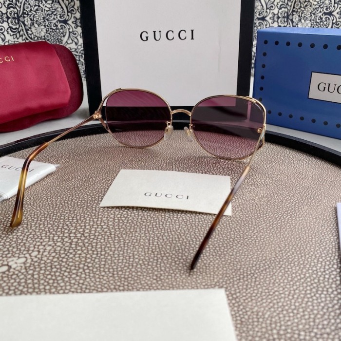 G*u*i oval metal sunglasses blue