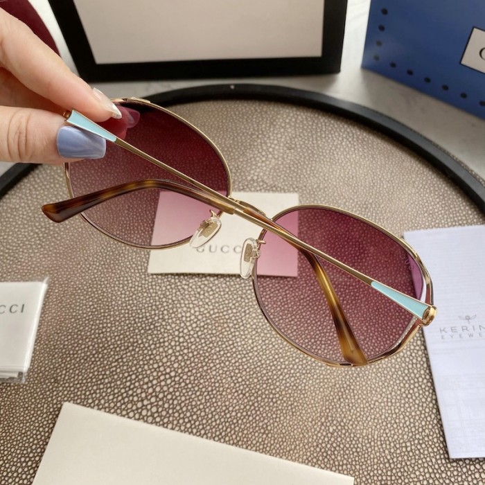 G*u*i oval metal sunglasses blue