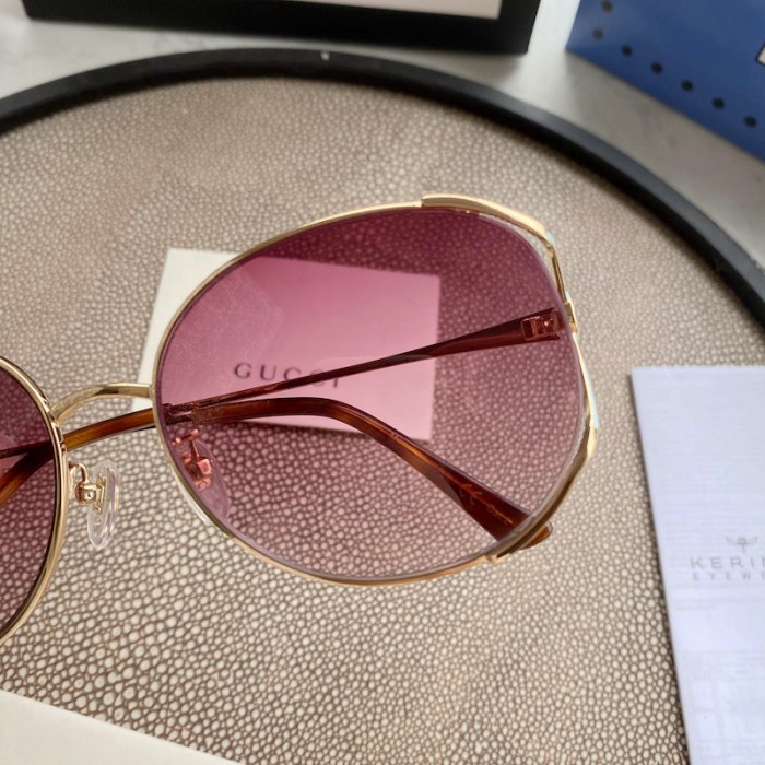 G*u*i oval metal sunglasses blue