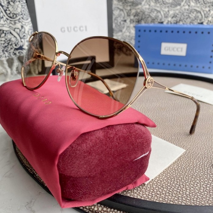 G*u*i oval metal sunglasses brown