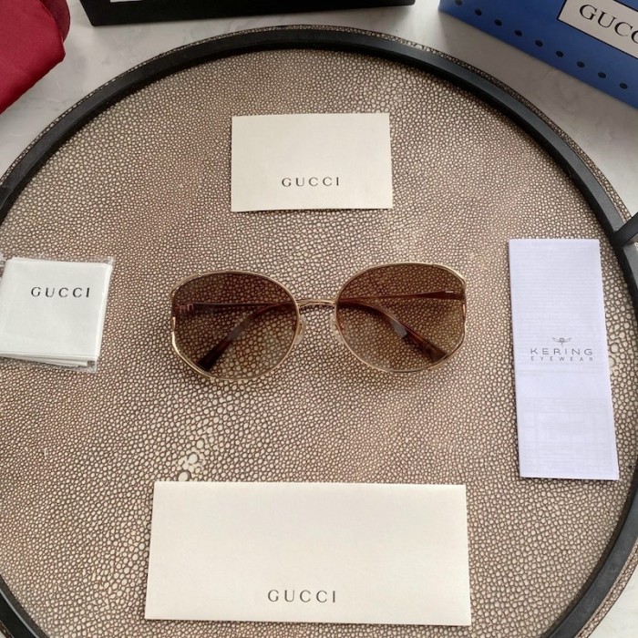 G*u*i oval metal sunglasses brown