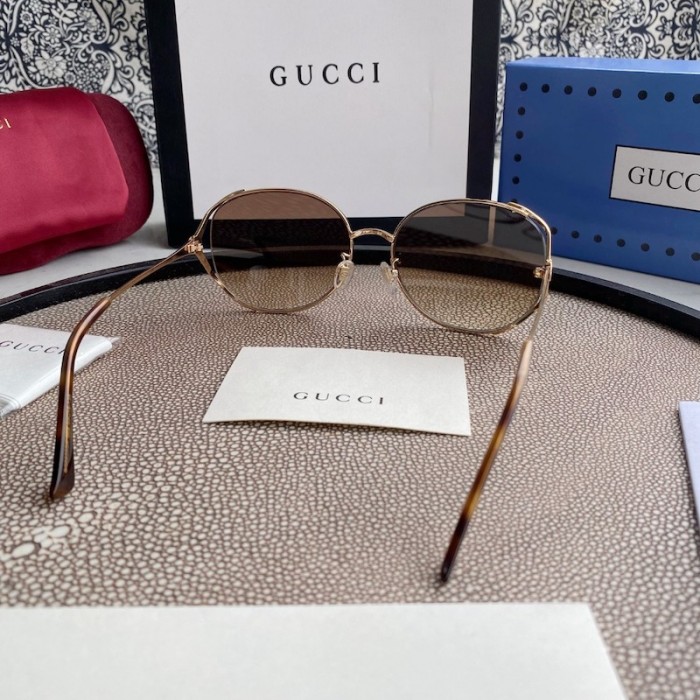 G*u*i oval metal sunglasses brown