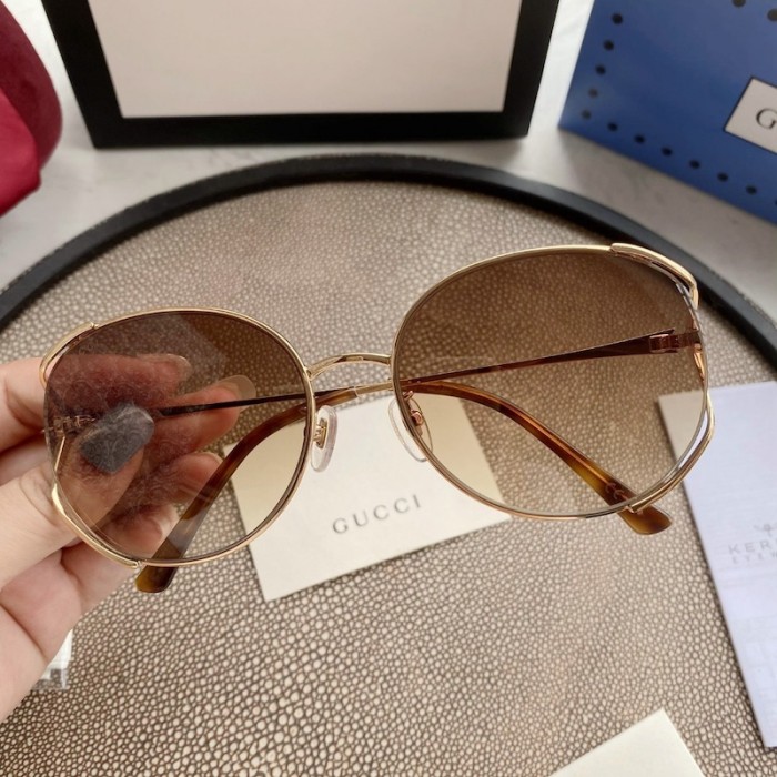 G*u*i oval metal sunglasses brown