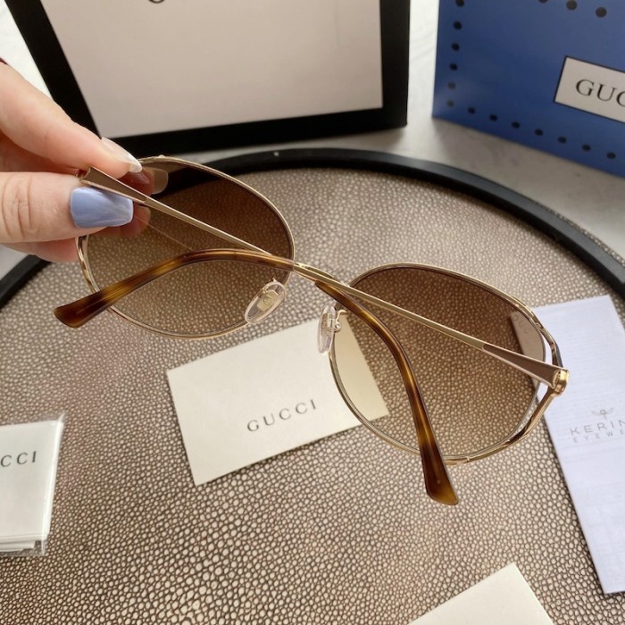 G*u*i oval metal sunglasses brown
