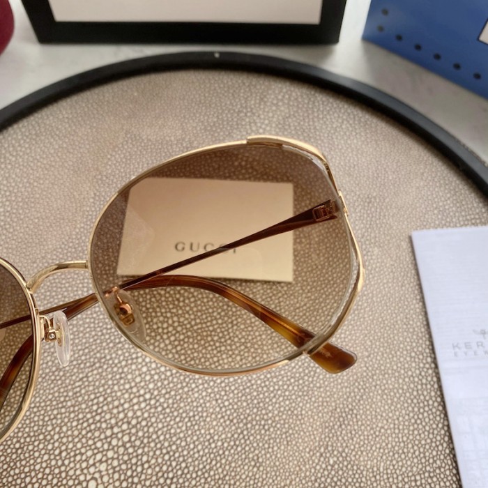 G*u*i oval metal sunglasses brown