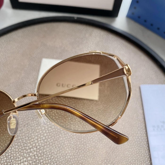 G*u*i oval metal sunglasses brown