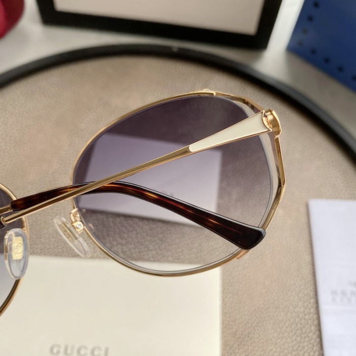 G*u*i oval metal sunglasses white